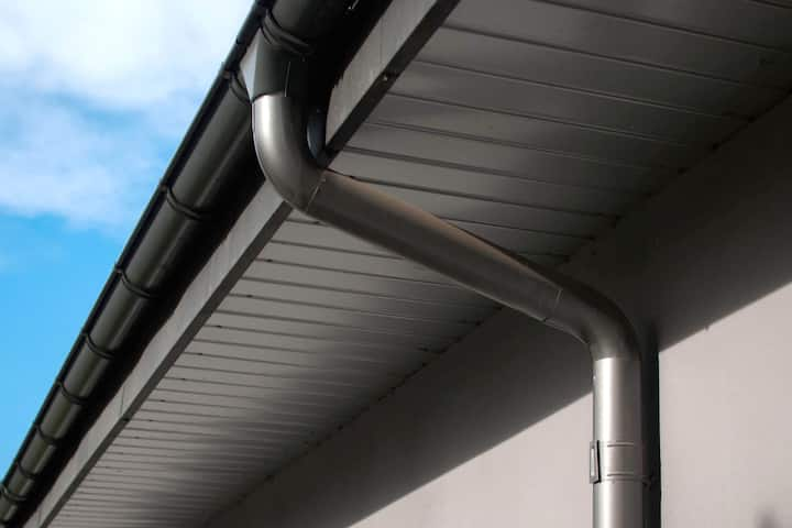 Corrosion-resistant galvanized gutters installed on a commercial building in Des Moines